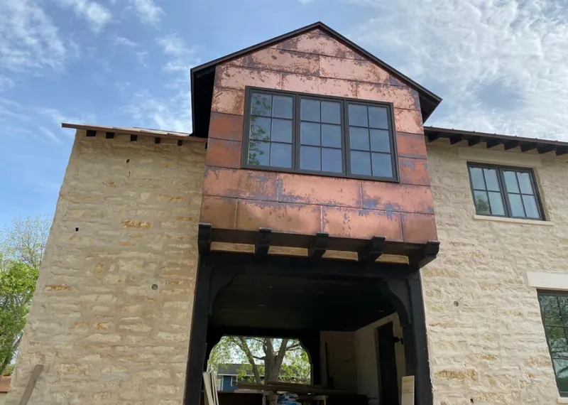 Copper metal panel facade on a stone building for Metal Roof Coating in Artesia