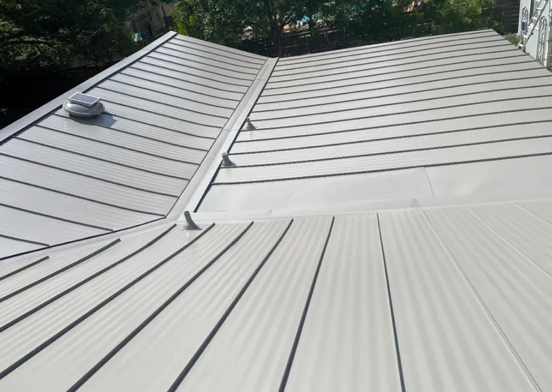 Solar attic fan installed on a metal roof for Roof Ventilation in Artesia